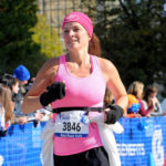 Turtle Gloves Running Lifestyle Female Athlete Running Race with Lightweight Turtle Flip Mittens dressed in pink and black